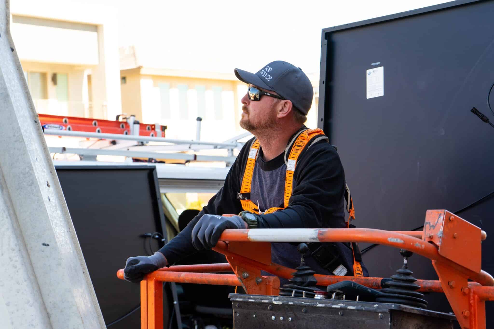 solar installer on a lift